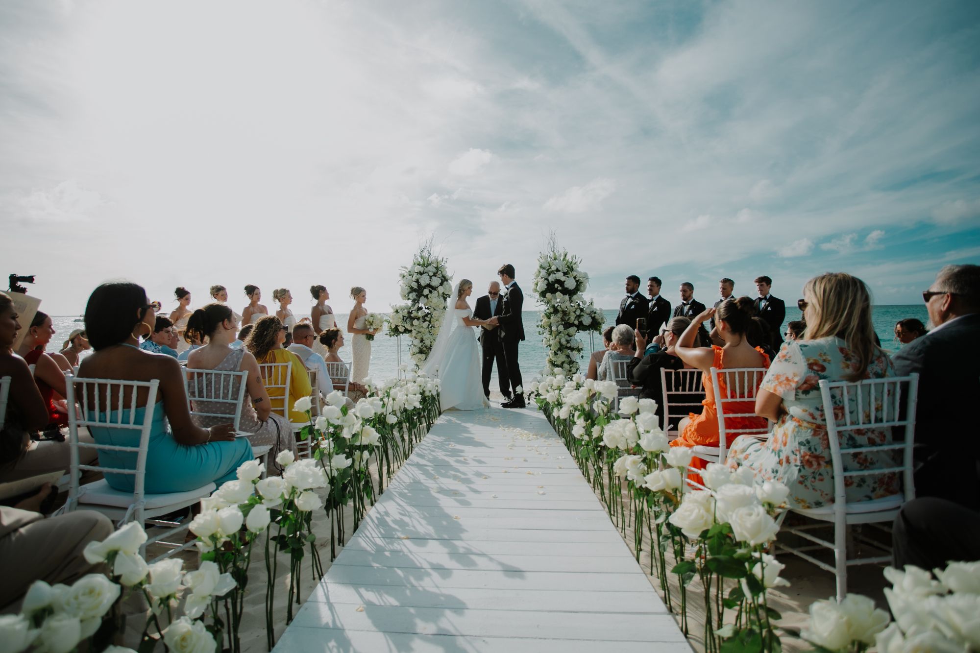 sarah and jackson exchanging vows in front of friends and family at beaches turks and caicos