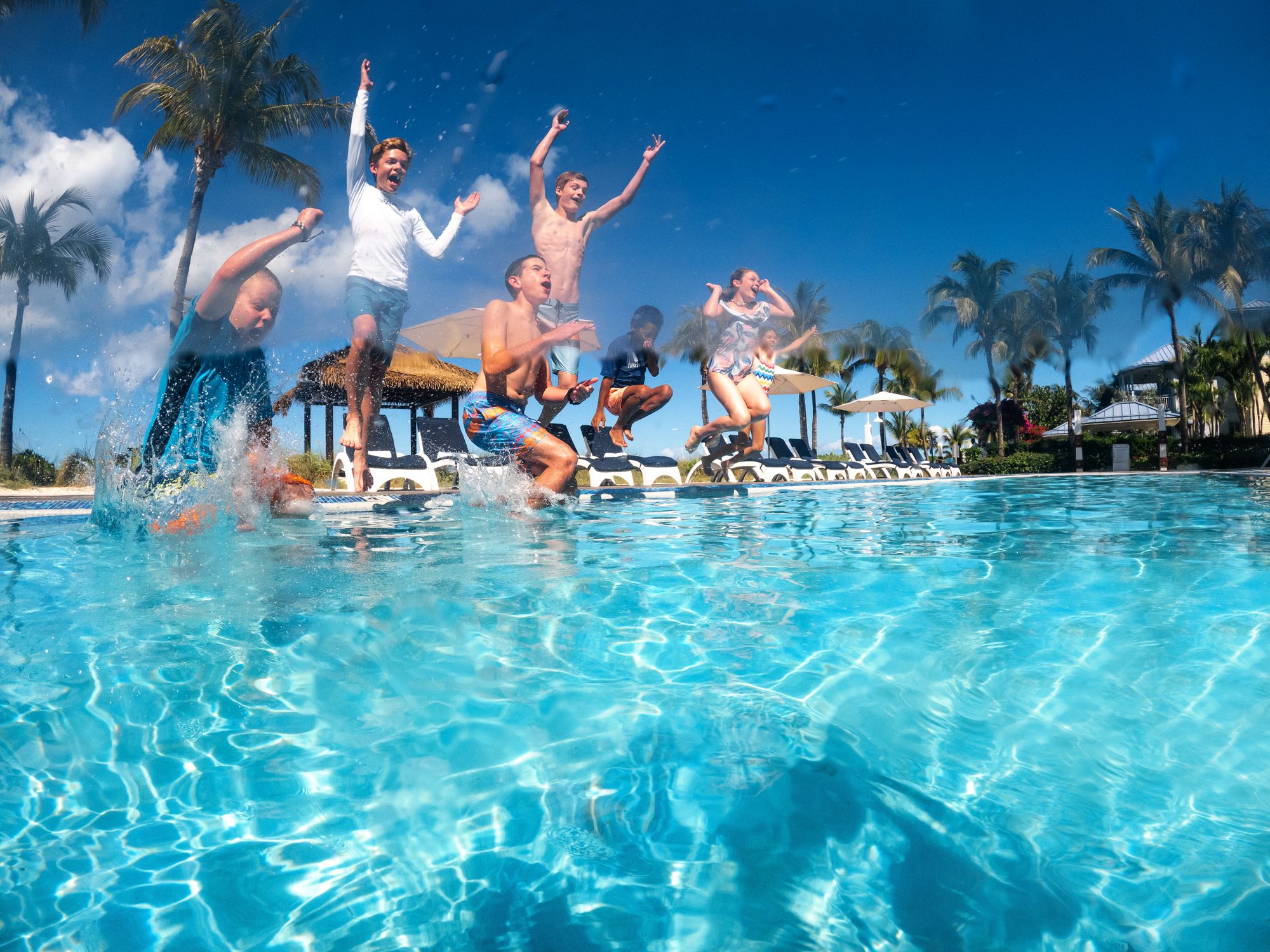 Kids jumping into pool