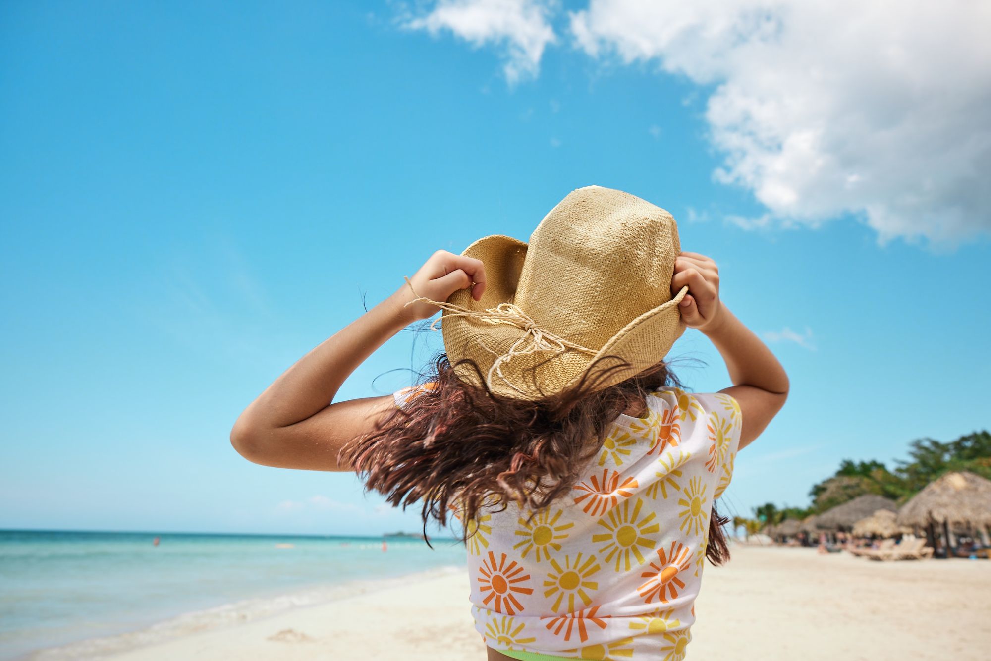 Little girl cowboy hat beach