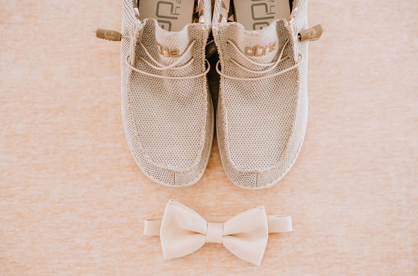 a pair of heydude shoes and bowtie used in the wedding