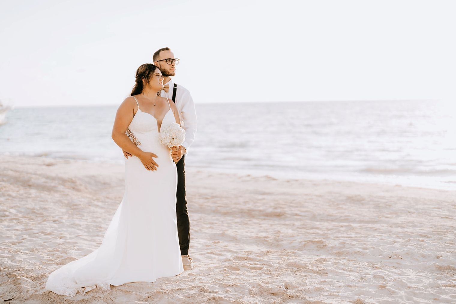 Bride-and-groom-posing-on-the-beach-with-scenic-Jamaica-sunset-in-the-background