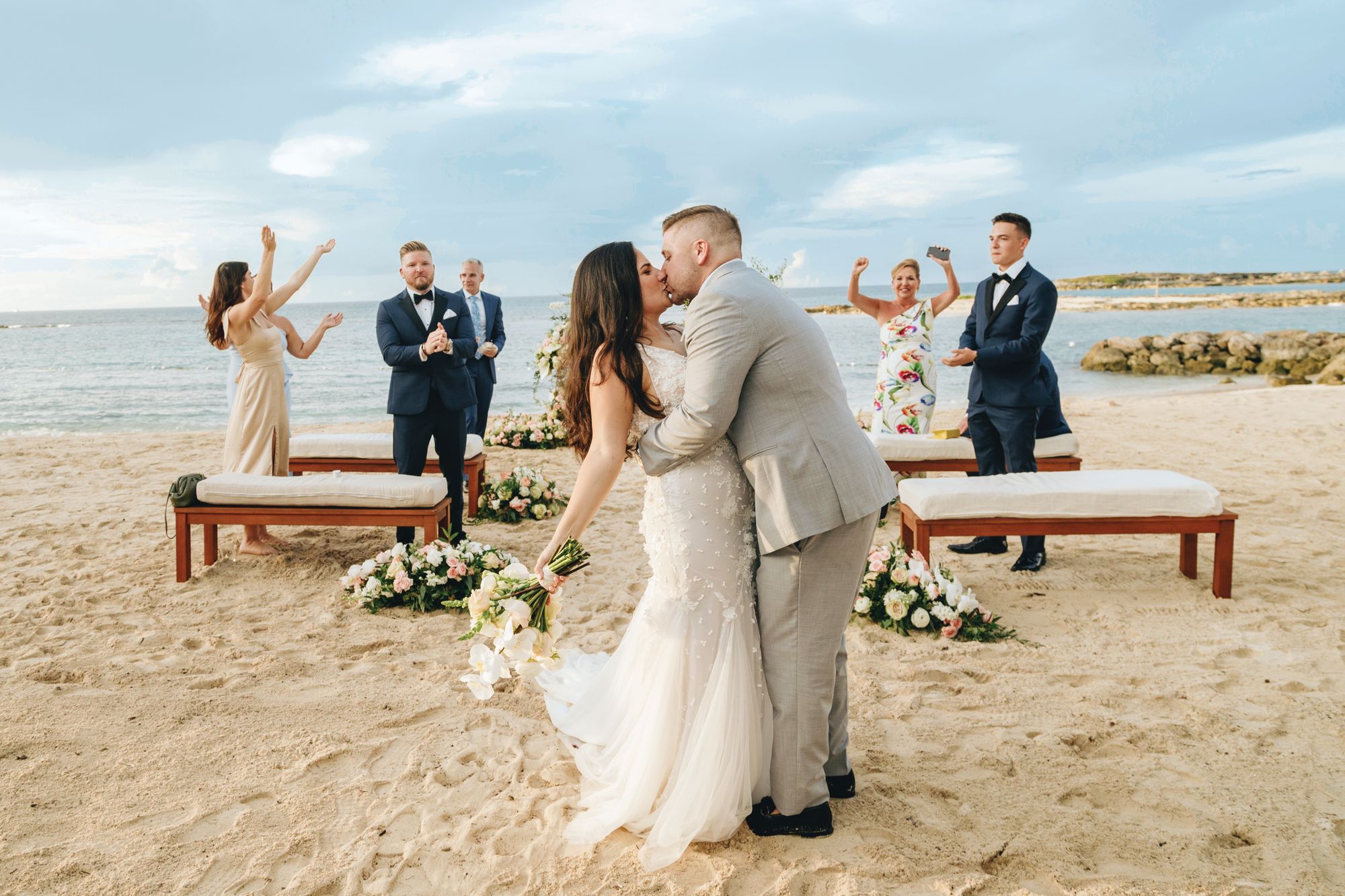 beach bride and groom kiss